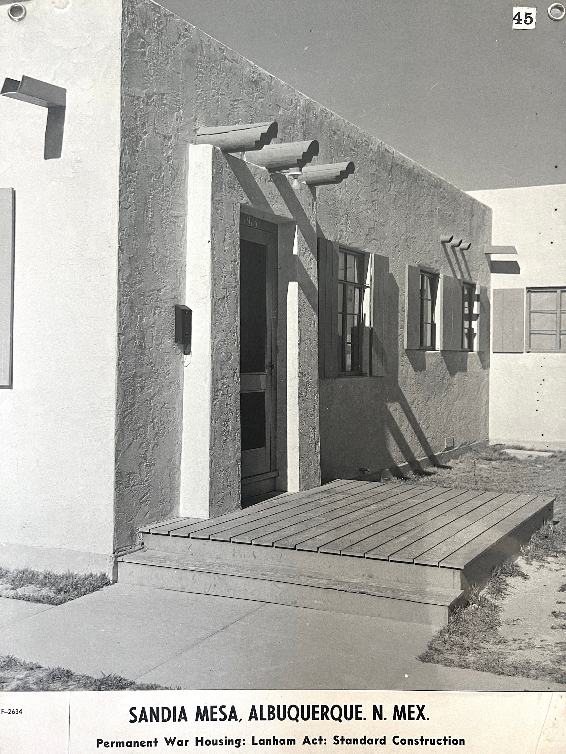 Black and white photo of a building with a wooden porch on Sandia Mesa, Albuquerque, N. Mex.